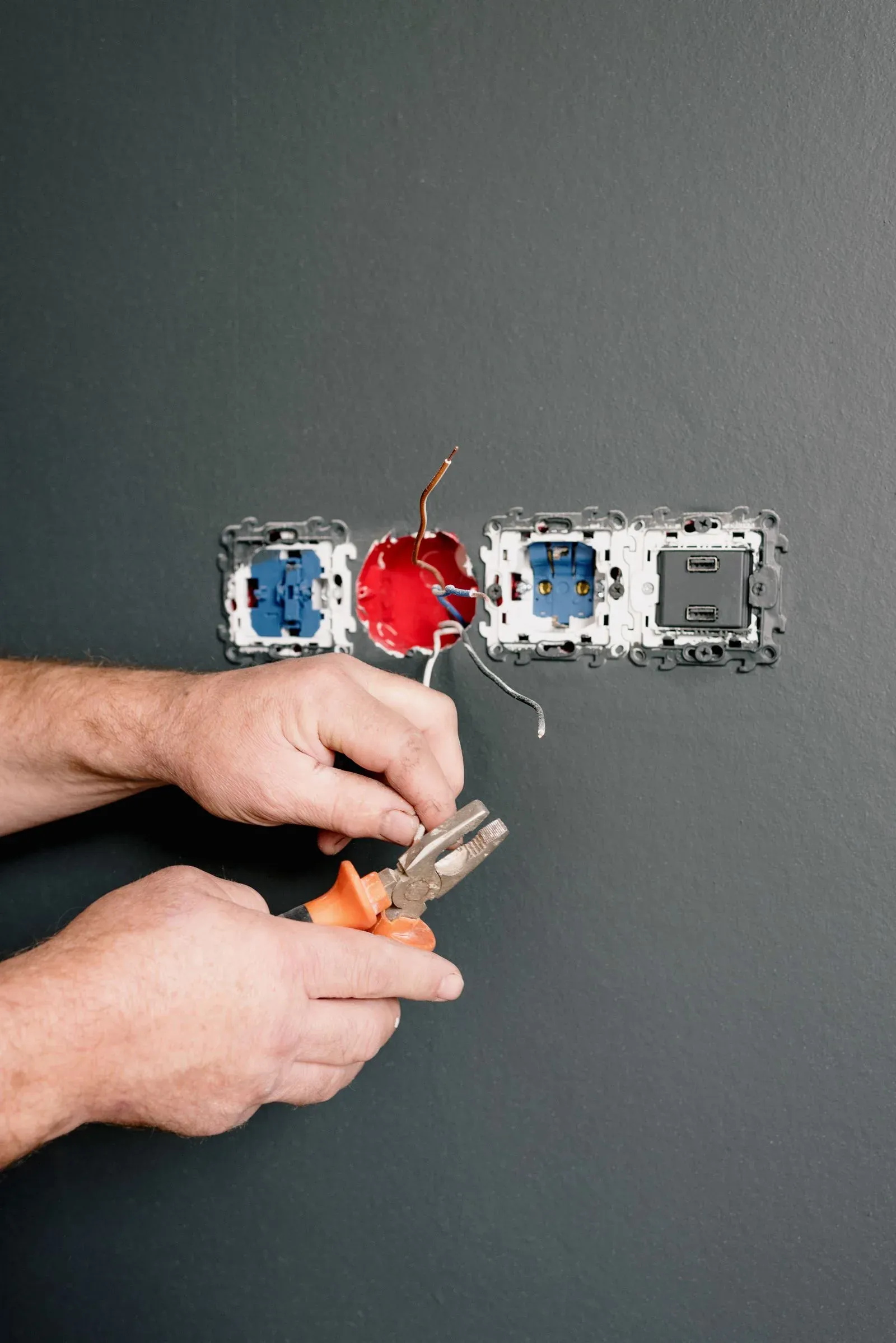 Electrician repairing a power socket