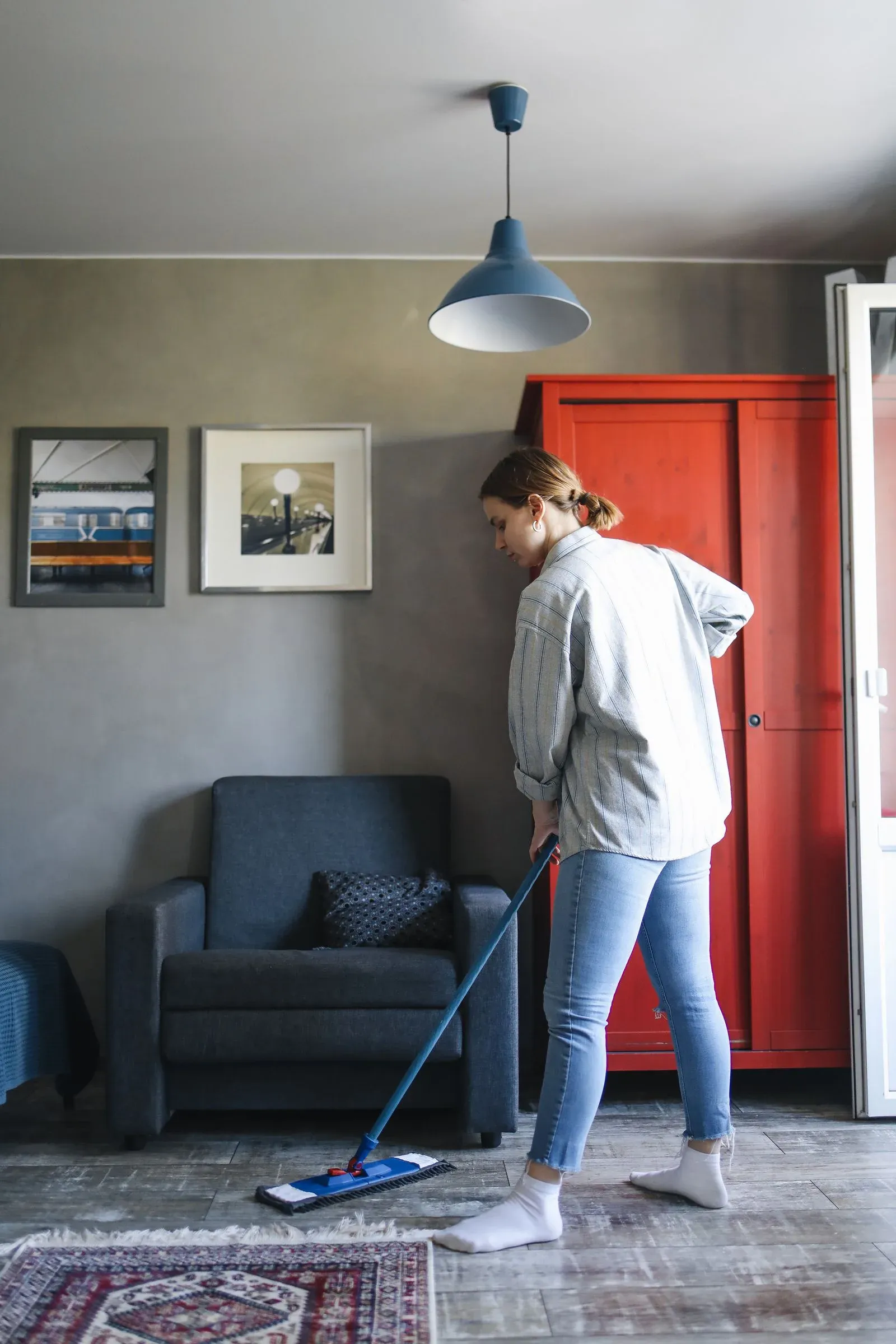 Cleaner mopping a floor during home cleaning