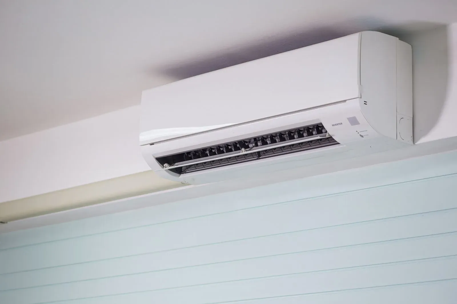 Wall-mounted split AC indoor unit on a white wall